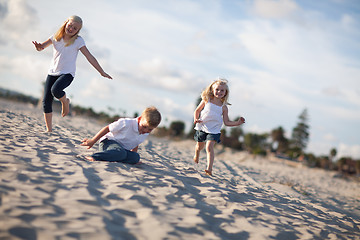 Image showing Adorable Brother and Sisters Having Fun at the Beach