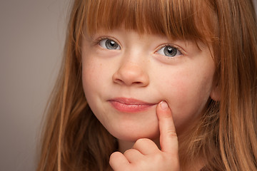 Image showing Fun Portrait of an Adorable Red Haired Girl on Grey