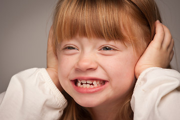 Image showing Fun Portrait of an Adorable Red Haired Girl on Grey