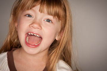 Image showing Fun Portrait of an Adorable Red Haired Girl on Grey