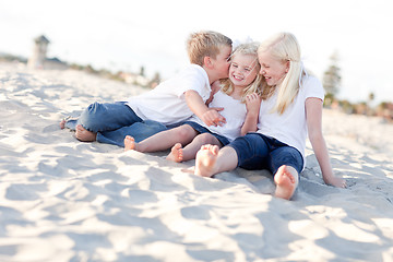 Image showing Adorable Sibling Children Kissing the Youngest