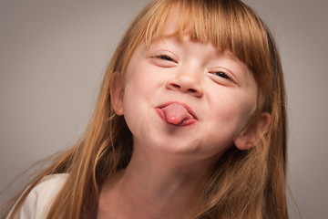 Image showing Fun Portrait of an Adorable Red Haired Girl on Grey