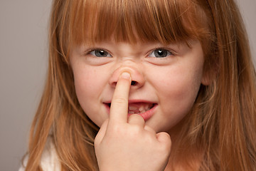 Image showing Fun Portrait of an Adorable Red Haired Girl on Grey