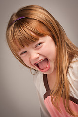 Image showing Fun Portrait of an Adorable Red Haired Girl on Grey