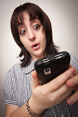 Image showing Stunned Brunette Woman Using Cell Phone