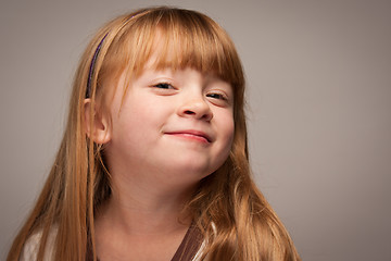 Image showing Fun Portrait of an Adorable Red Haired Girl on Grey