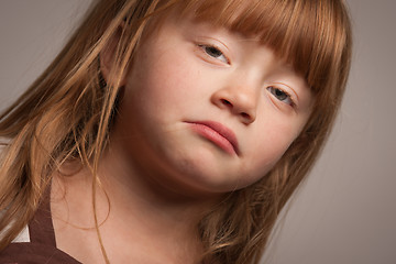 Image showing Fun Portrait of an Adorable Red Haired Girl on Grey