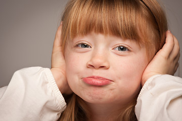 Image showing Fun Portrait of an Adorable Red Haired Girl on Grey