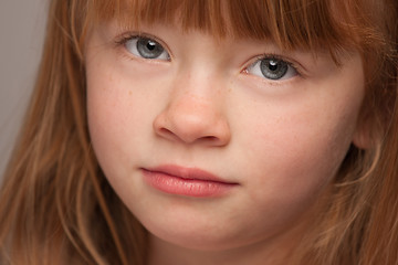 Image showing Fun Portrait of an Adorable Red Haired Girl on Grey