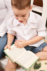 Image showing Cute Young Boy Reading His Book