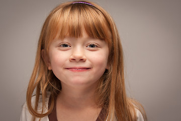 Image showing Fun Portrait of an Adorable Red Haired Girl on Grey