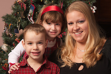 Image showing Cute Children and Mother Posing in Front Of Holiday Tree