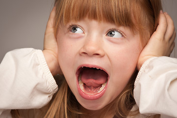 Image showing Fun Portrait of an Adorable Red Haired Girl on Grey