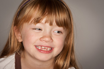 Image showing Fun Portrait of an Adorable Red Haired Girl on Grey