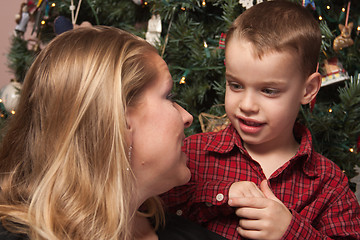 Image showing Adorable Son Talking to Mom in Front Of Christmas Tree