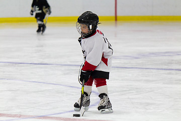 Image showing Little boy playing ice hockey