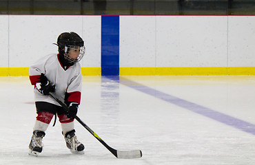 Image showing Little boy playing ice hockey