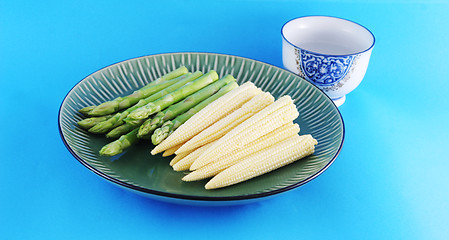 Image showing Fresh asparagus shoots and corn on a plate