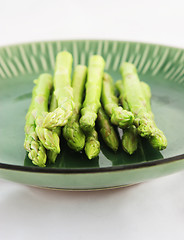Image showing Fresh asparagus shoots on a plate