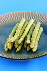 Image showing Fresh asparagus shoots on a plate