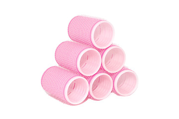 Image showing Six pink velcro rollers stacked in a pyramid