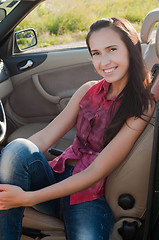 Image showing Smiling brunette woman in car