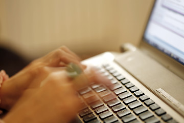 Image showing Young woman working on laptop