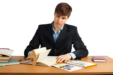 Image showing cute man reading a book at table