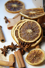 Image showing Cinnamon sticks and dry orange