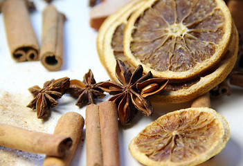 Image showing Mix of cinnamon sticks and dry orange