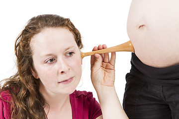 Image showing midwife listening at human belly