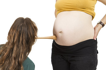 Image showing midwife listening at human belly