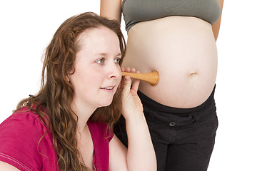 Image showing midwife listening at human belly