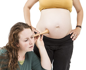 Image showing midwife listening at human belly