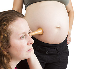 Image showing midwife listening at human belly