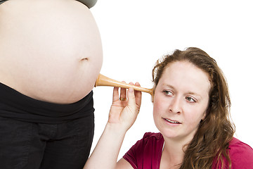 Image showing midwife listening at human belly