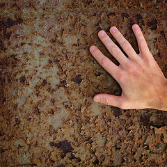 Image showing Hand on old rusty metal surface