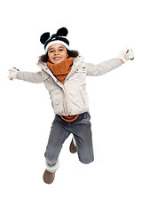 Image showing Excited primary girl jumping with joy