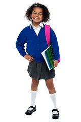 Image showing Girl in smart uniform holding notebook and calculator