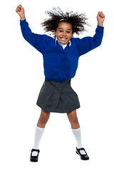 Image showing Pretty African school girl dances in full swing