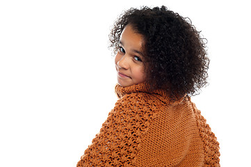 Image showing Little girl with over sized sweater on turning back