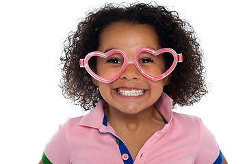 Image showing Pretty girl with a wide grin. Wearing funny frame