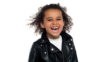 Image showing Profile shot of an elementary kid laughing heartily