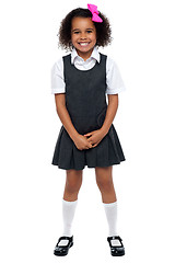 Image showing Cheerful young kid in pinafore dress posing smilingly