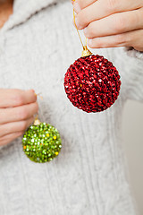 Image showing Red and green Christmas baubles