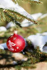 Image showing christmas balls on outdoor snowy tree