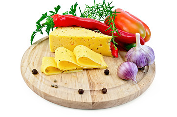 Image showing Cheese with pepper and herbs on a round board