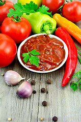 Image showing Ketchup with vegetables and spices on an old board