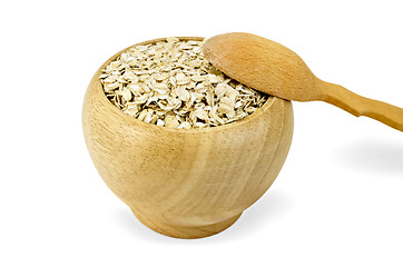 Image showing Oat flakes in a wooden bowl with a spoon