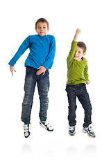 Image showing Two boys jumping on white background.